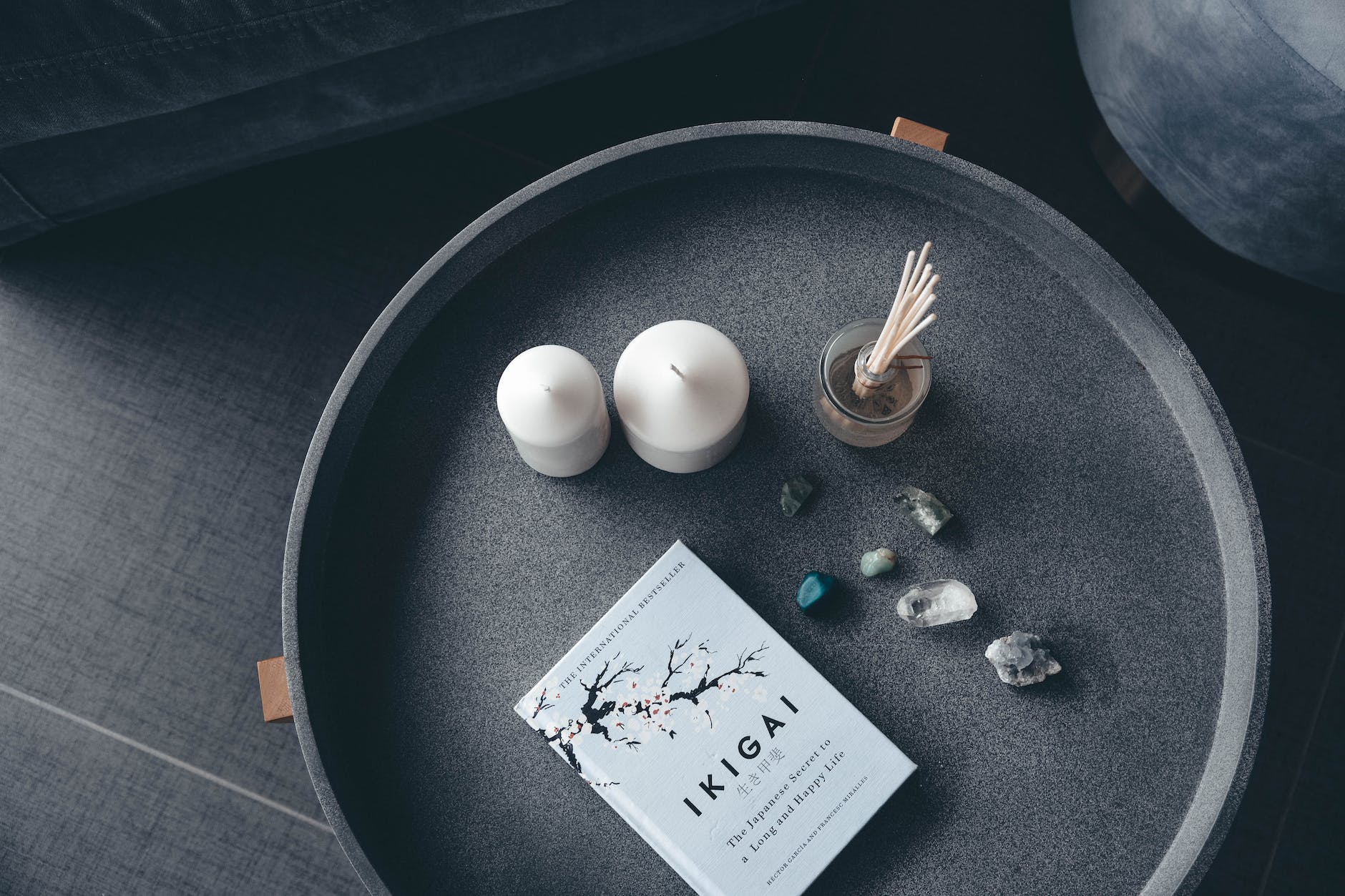 photo of candles stones and book